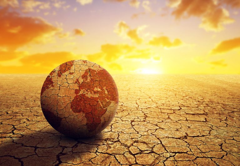 Parched planet earth in the dry landscape with cracked soil at sunset. Global warming or change climate concept. Environmental problems 10 Causes of Global Warming