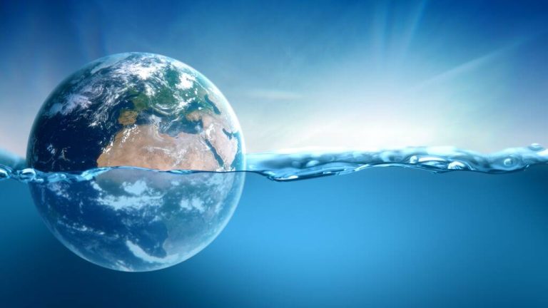 Planet Earth is submerged, floating in water. This concept illustration represents global warming and rising sea levels.