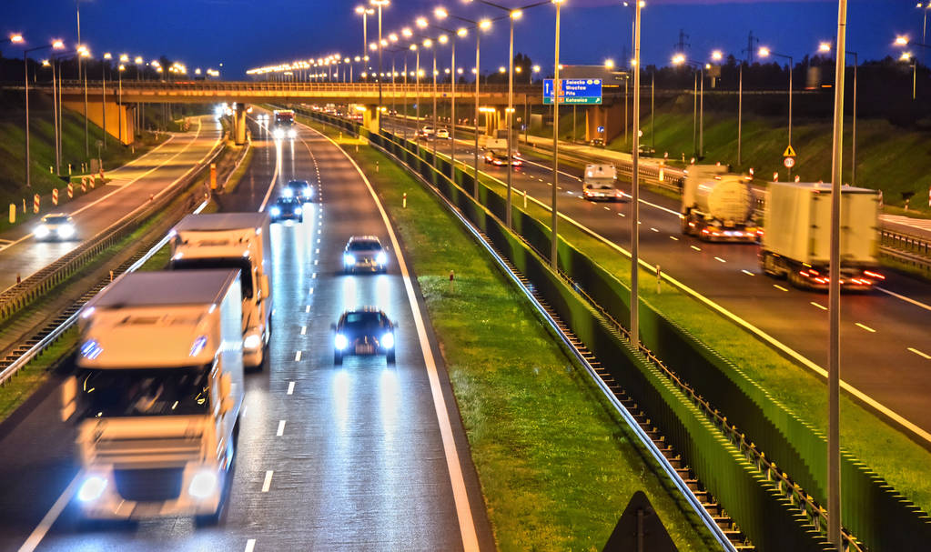 Trucks are on a four-lane controlled-access highway in Poland.