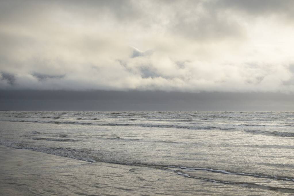 Baltic sea after the storm. Soft sunset light, dramatic glowing clouds. Seascape, cloudscape, nature. Panoramic view. Ecology, climate change, weather